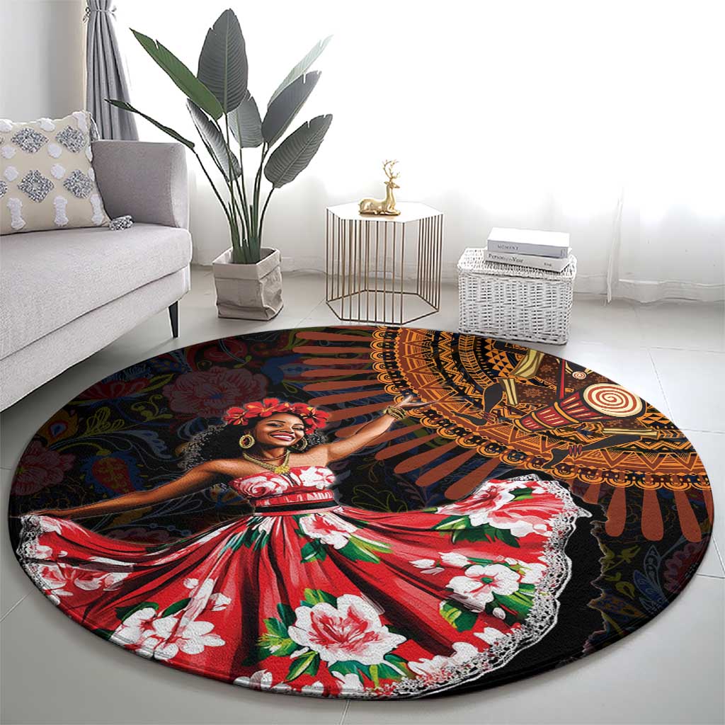Round black rug featuring African dance figure in red floral dress with orange and yellow motifs