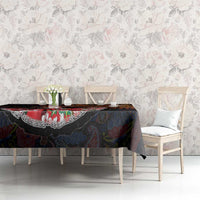 Dark paisley tablecloth with colorful floral motifs and decorative border on dining table