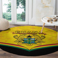 Round yellow carpet with Ghana coat of arms crest and multicolor stripe band on black edge