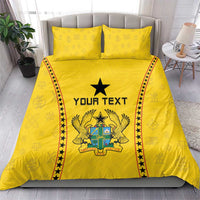 Yellow duvet and two pillowcases with centered black star, crest graphic, and red/black borders