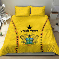 Yellow duvet and two pillowcases featuring black star, “YOUR TEXT,” and crest emblem borders