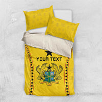 Yellow bedding set top view with duvet and two pillows, black star and “YOUR TEXT” panel