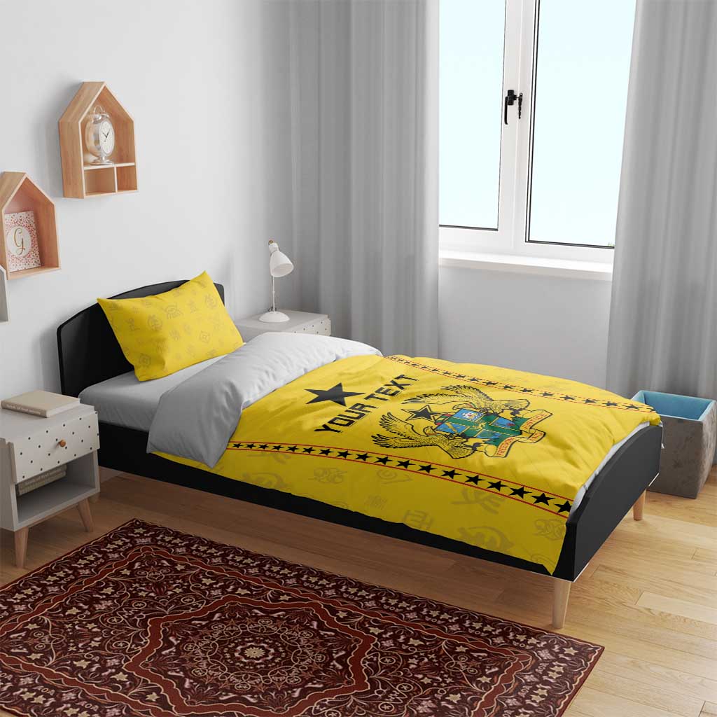Yellow bedding set on bed with duvet showing crest graphic, black star, and “YOUR TEXT”