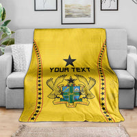 Yellow football blanket spread with black star trim and central 'YOUR TEXT' coat-of-arms