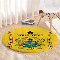 Round yellow rug with 'Your Text' and star crest, decorative red and black border