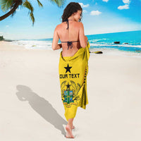 Yellow Ghana football sarong with large black star emblem and OUR TEXT print on back