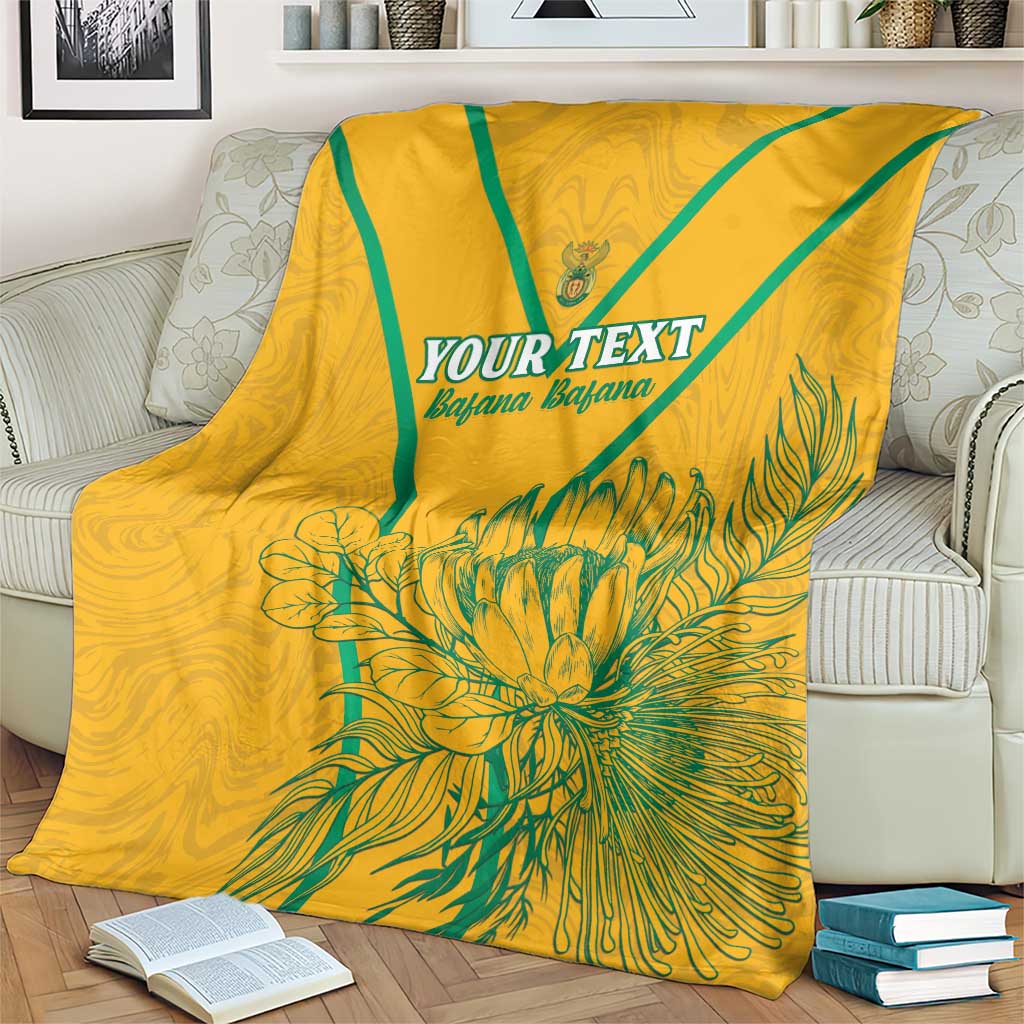 Yellow soccer blanket with teal diagonal stripe and floral burst, 'YOUR TEXT' centered
