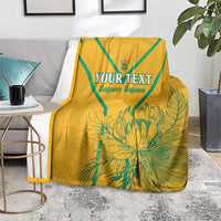Yellow soccer blanket with teal stripes and 'YOUR TEXT' floral print, draped on bench
