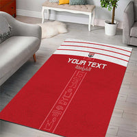 Red custom area rug with white border stripes, "YOUR TEXT" and pharaoh icon graphic