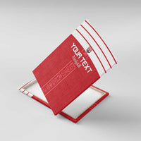 Red canvas wall art tilted on stand, showing white stripe header and vertical hieroglyph graphic