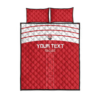 Red quilt bed set with 'YOUR TEXT' and Arabic text; two square pillows