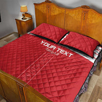 Red quilt bed set with 'YOUR TEXT' stripe detail; two quilted pillows
