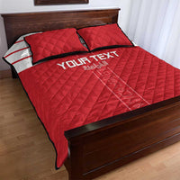 Red quilt bed set with 'YOUR TEXT' and white stripe; two pillows on wooden bed