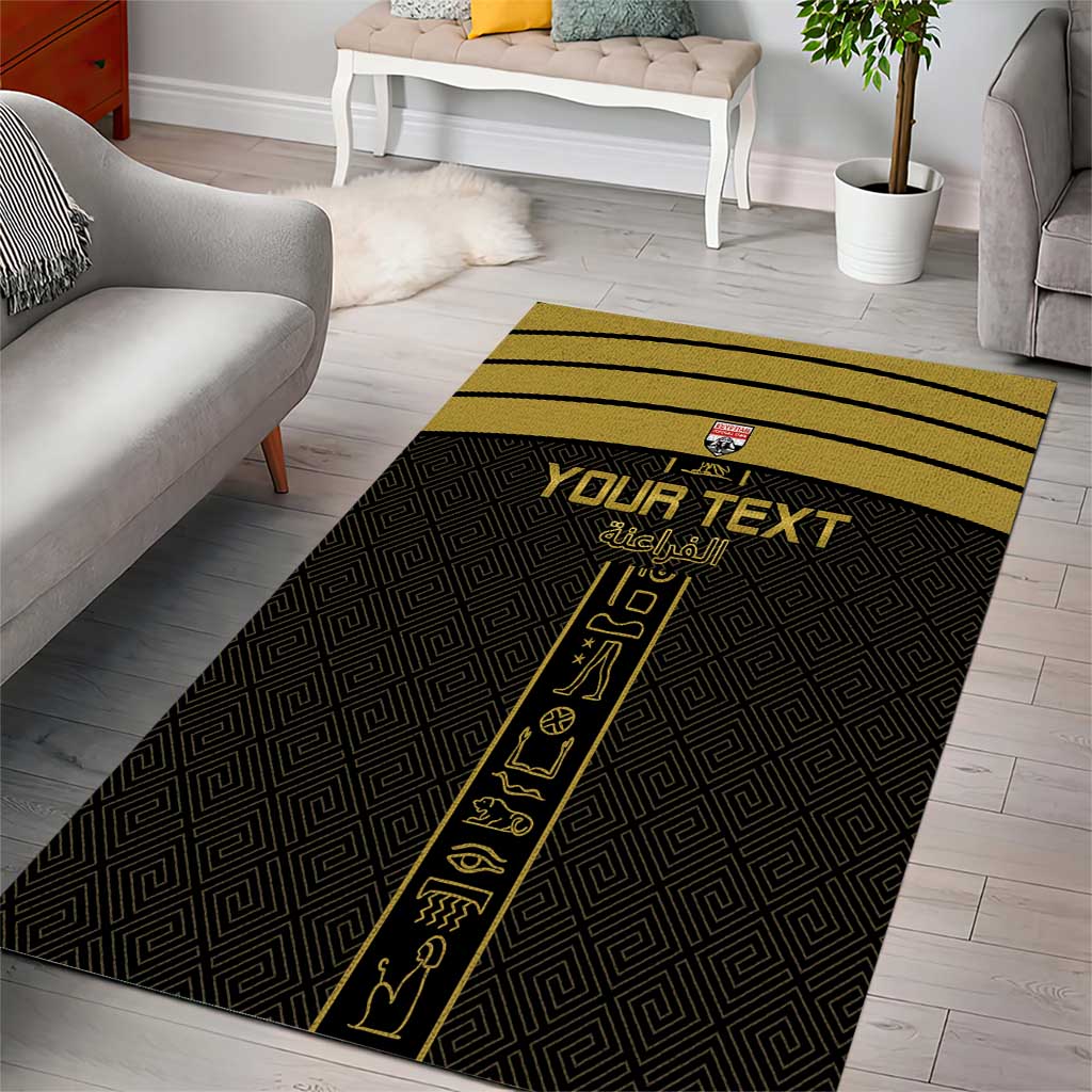 Rectangular black area rug with yellow stripe, Egyptian symbols, and custom text in center