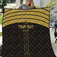 Custom football quilt with black base, gold stripes, and vertical gold emblem design