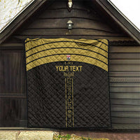 Black custom football quilt hanging indoors with gold stripes and vertical emblem panel