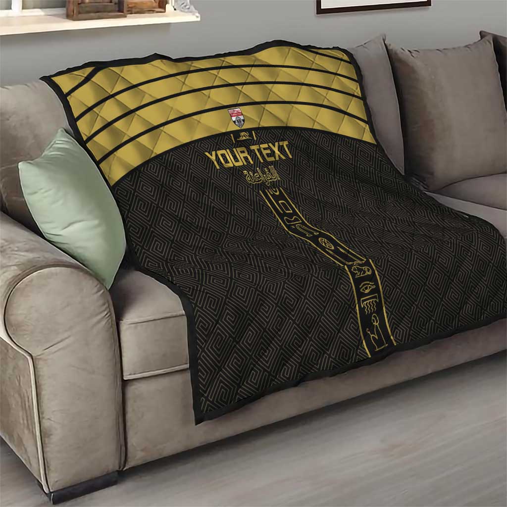Black custom football quilt with gold stripes and vertical emblem on a sofa