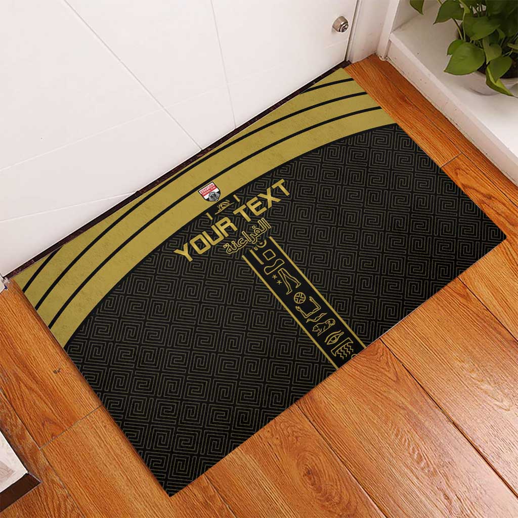 Black rubber doormat with yellow stripes and custom text, set on wooden floor by door