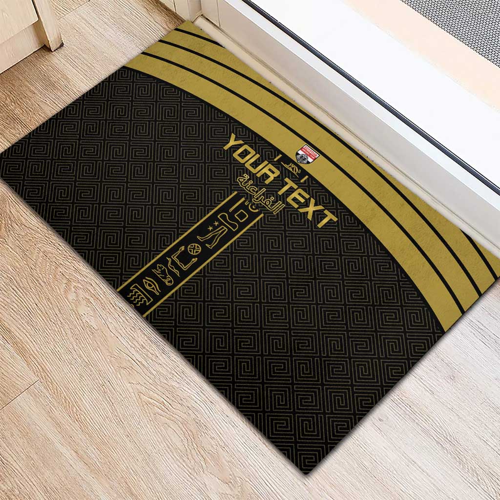 Black rubber doormat with yellow top stripes and custom text design with gold figures