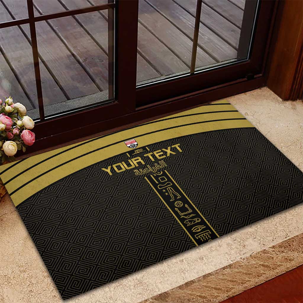 Black rubber doormat with yellow border and central custom text, placed at entryway