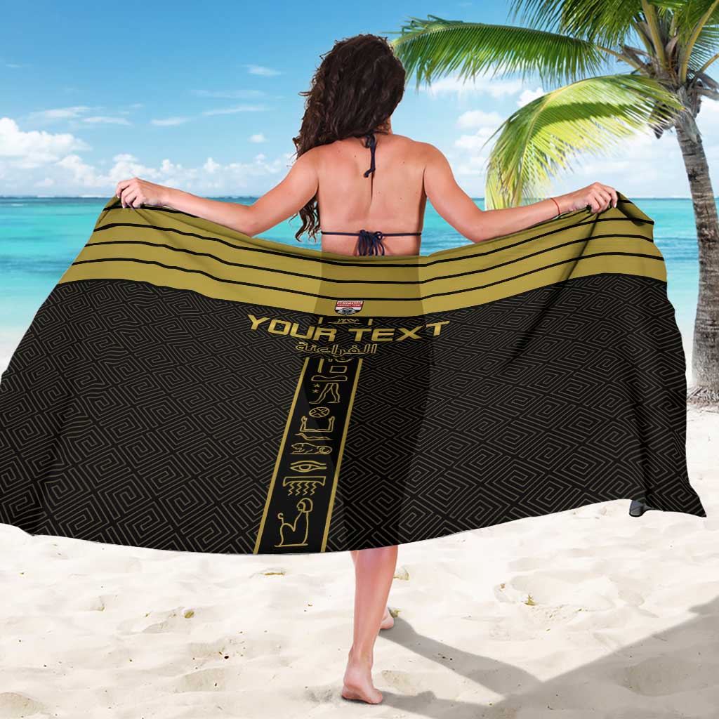 Black sarong with gold trim stripe, diamond pattern, and “Your Text” front print