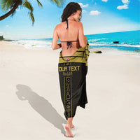 Black wrap sarong with gold central stripe and hieroglyph-style “Your Text” design