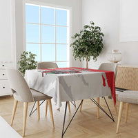 White football tablecloth draped on dining table with red stripe and crest design