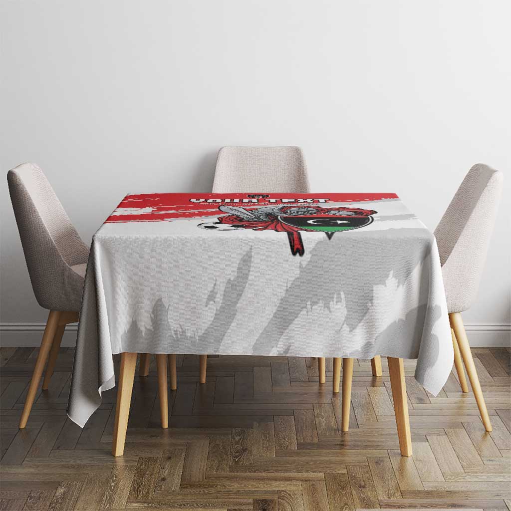 White football tablecloth covering dining table with red brush stripe and crest artwork