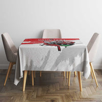 White football tablecloth covering dining table with red brush stripe and crest artwork