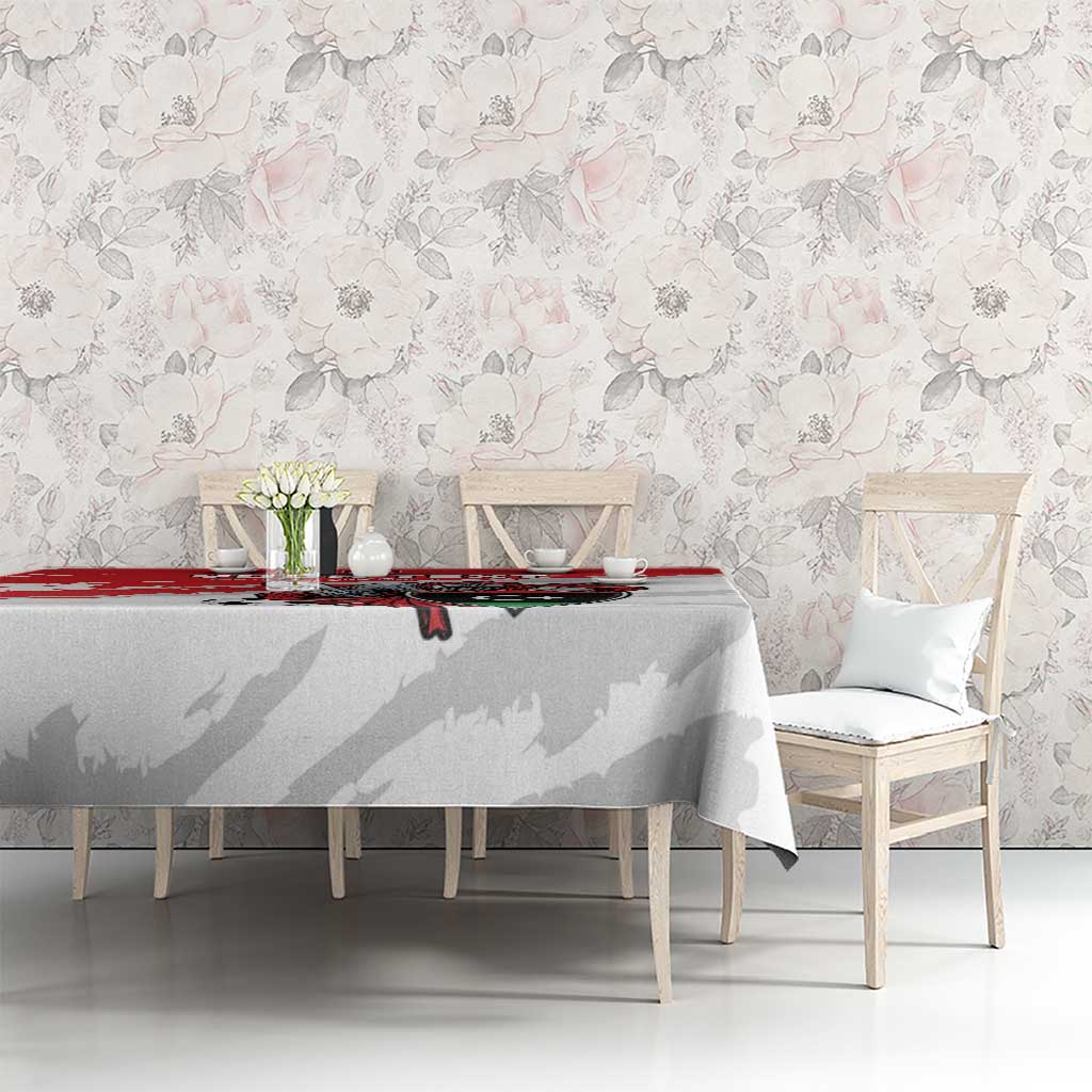 White football tablecloth with red stripe and Libya crest, on dining table against wall
