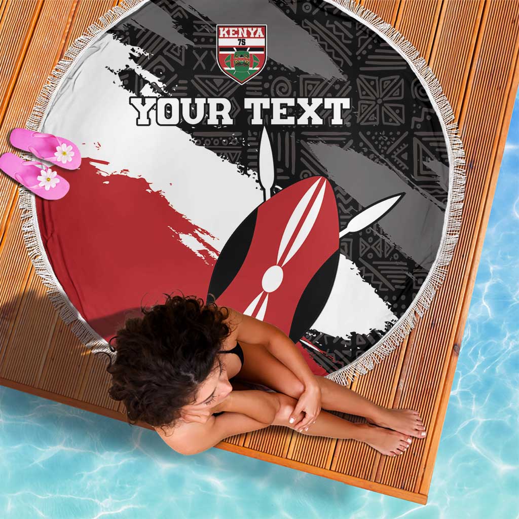 Round fringe beach blanket with black, white, red African pattern and surfboard graphic