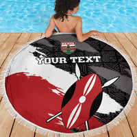 Round fringe beach blanket on wooden deck in black, white, red with surfboard design