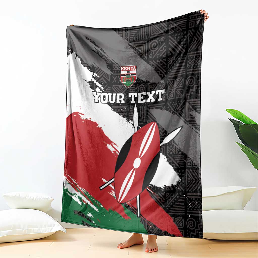 Kenya rugby blanket draped with black geometric pattern, red and green brush stripes, umbrella