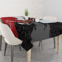 Black tablecloth showing red and green diagonal sections with African pattern
