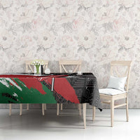 Black patterned tablecloth with red and green sections, placed on dining table