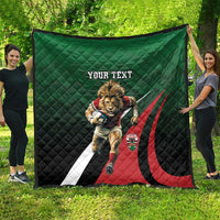 Green quilt laid out flat with lion rugby graphic, red/black curved stripes, 'YOUR TEXT'