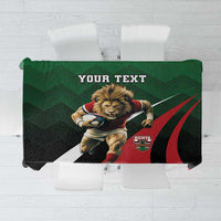 Custom tablecloth in green, black, and red with lion graphic and crest design