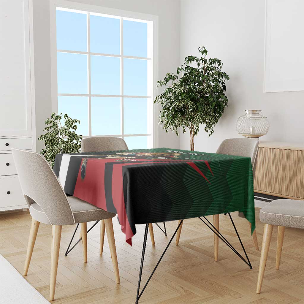 Green, black, and red custom tablecloth with rugby-style graphic on dining table