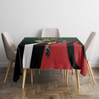 Green, black, and red custom tablecloth with geometric rugby-style design on table