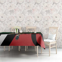Green, black, and red rectangular custom tablecloth on dining table with matching chairs