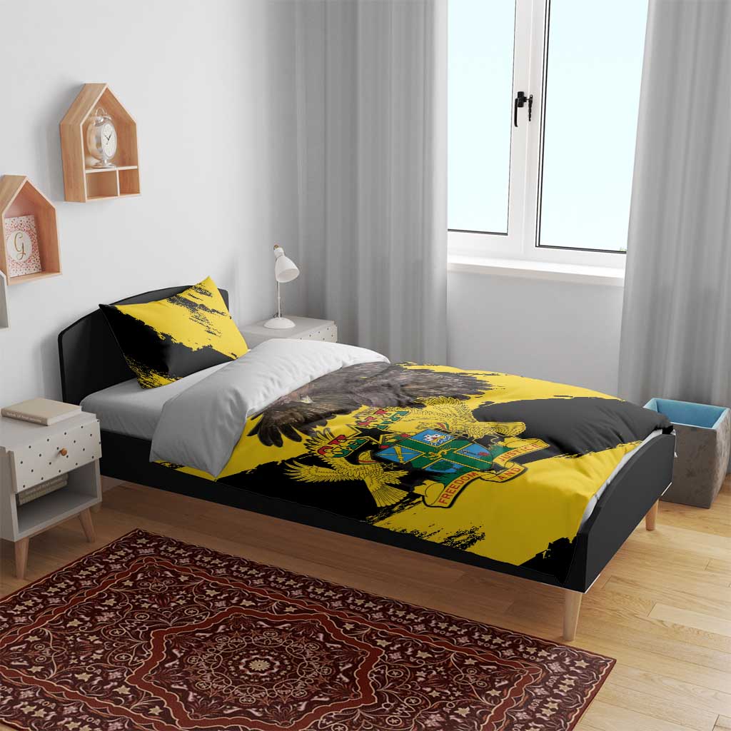 Yellow and black duvet cover with Ghana coat of arms and eagle wing design on bed