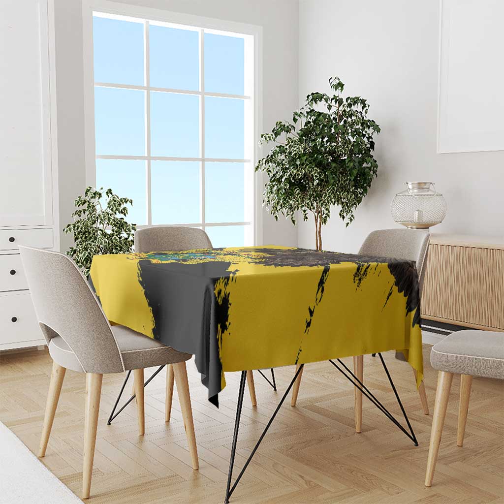 Grunge-style yellow and black tablecloth over a rectangular dining table with chair covers.