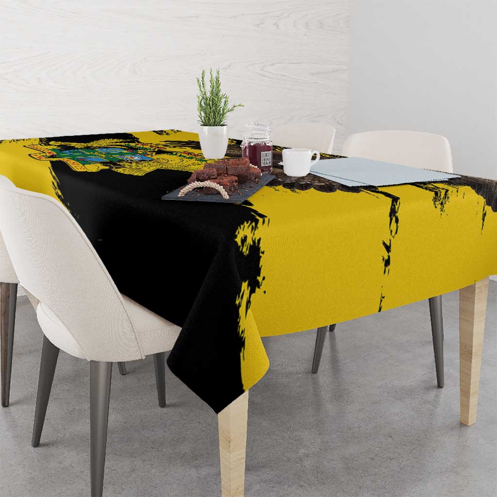 Yellow and black grunge tablecloth with diagonal brush strokes, styled on a dining table.