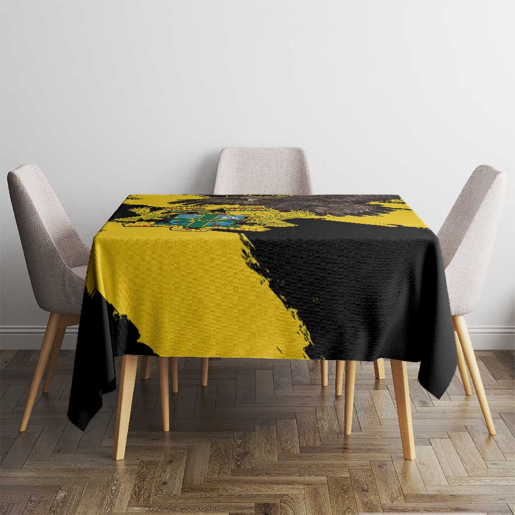 Yellow and black grunge tablecloth draped over a small square table, minimal dining setup.