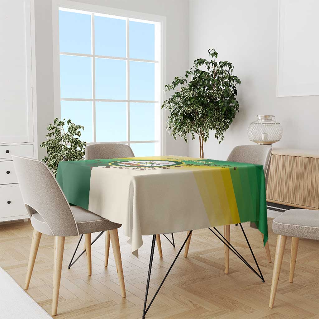 Nairobi tablecloth in green and cream with yellow stripe and circular emblem on table
