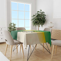 Nairobi tablecloth in green and cream with yellow stripe and circular emblem on table
