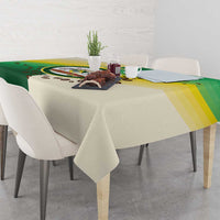 Corner view of green and cream Nairobi tablecloth with circular emblem and striped band