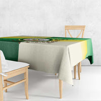 Green and cream Nairobi tablecloth with circular emblem, draped over table edge