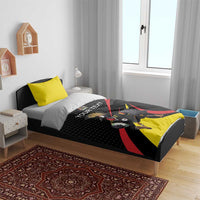 Black and yellow rugby bedding set on a bed with crowned crane mascot and red accents