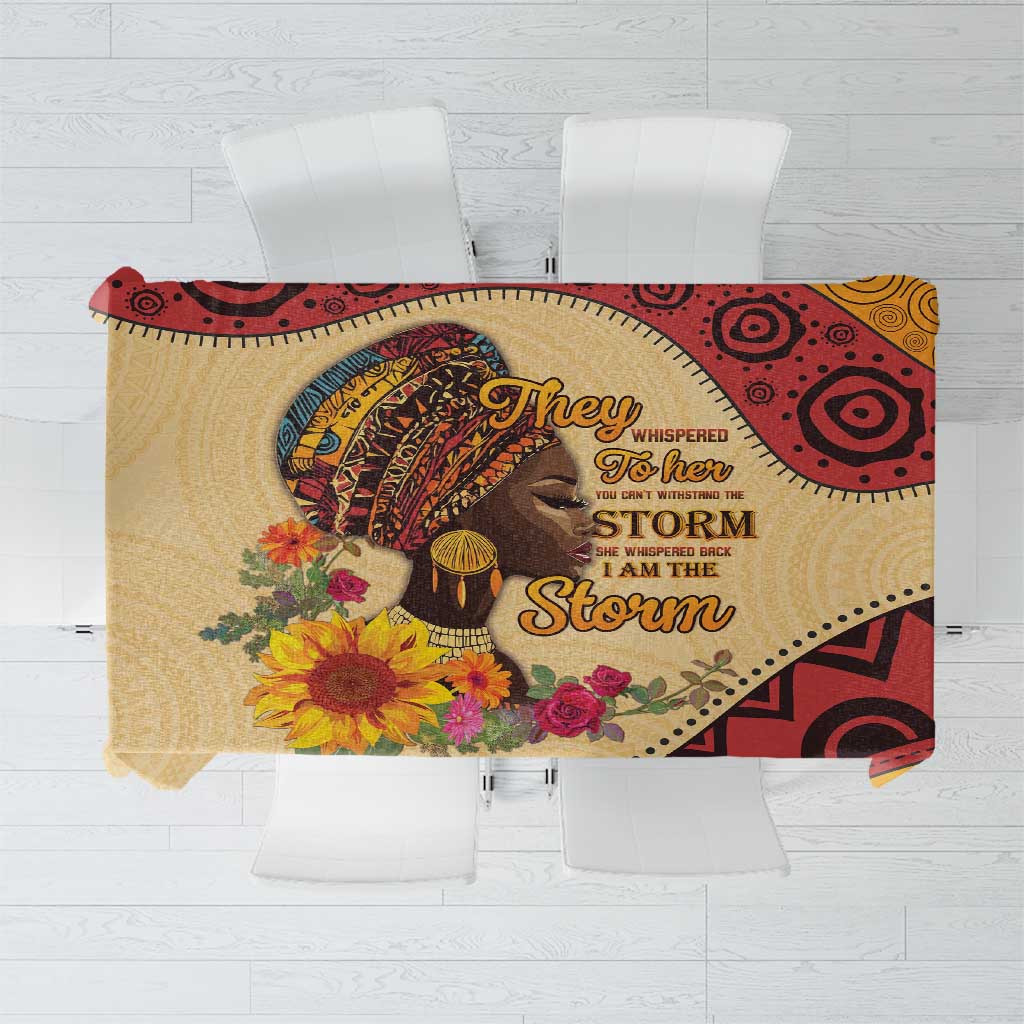 African-inspired tablecloth with bold geometric and portrait design in red and gold tones